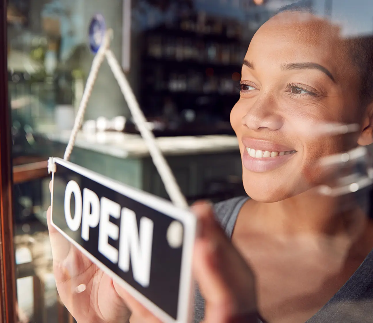 black woman changing sign to open